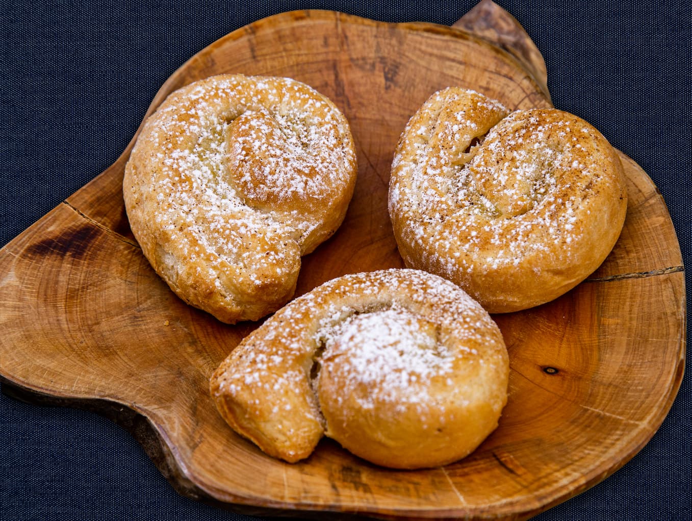 Pães sobre um cesto ao lado de uma xícara de café